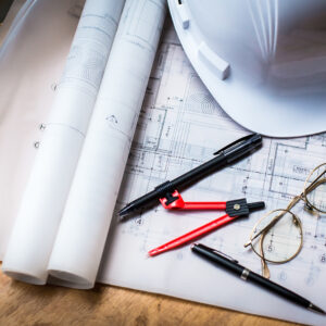 construction concept image helmet rolled blueprints on wooden boards in retro style.